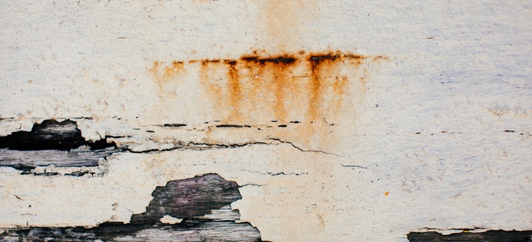 Damaged paint on a wooden wall.