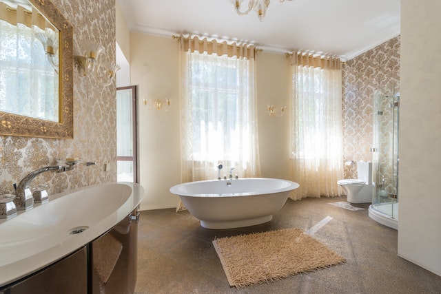 A bathroom with a rug and a large bathtub