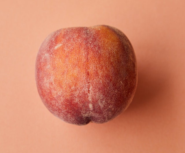 A peach on an orange background