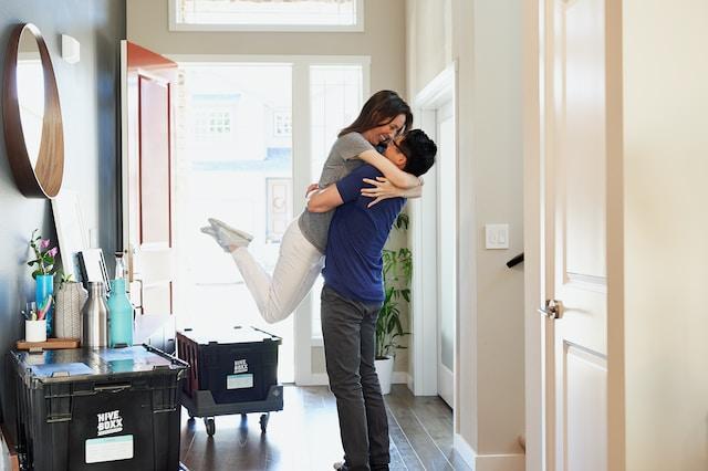 man hugging woman after moving in