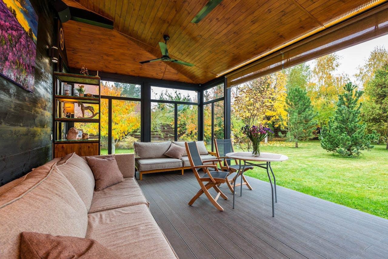 Terrace with comfortable couches and armchairs around the table.