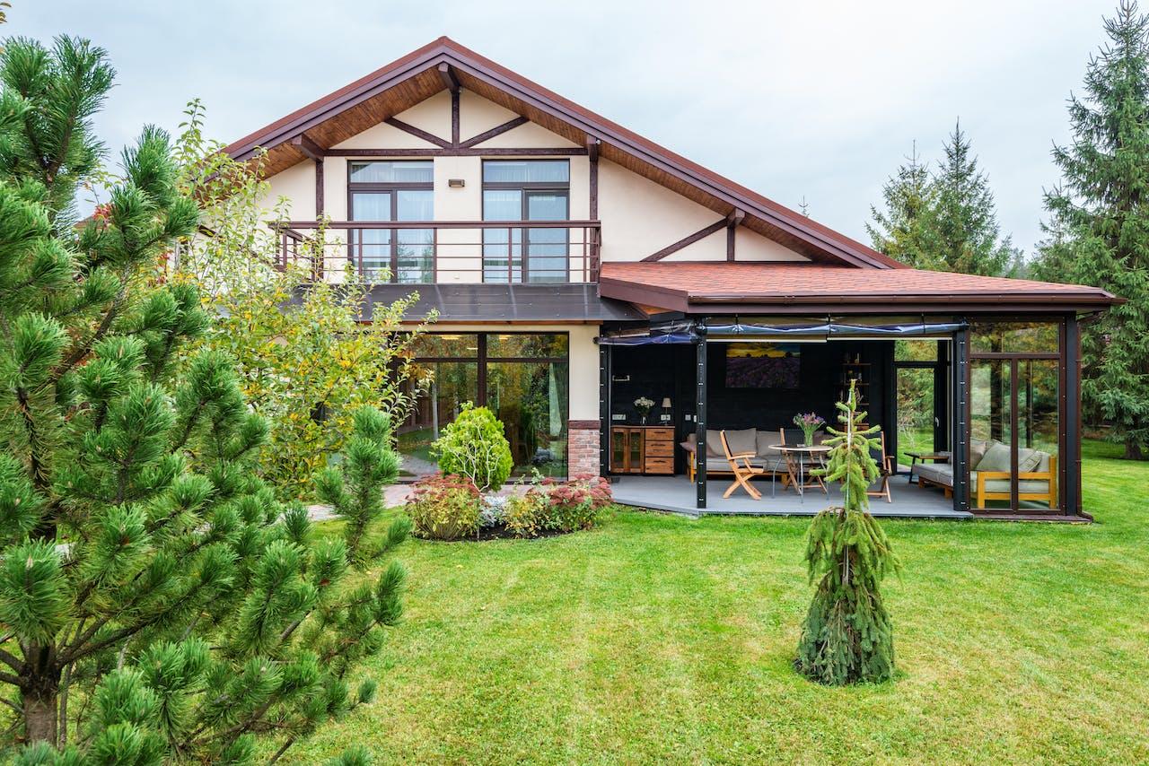 A green backyard of a modern cottage.