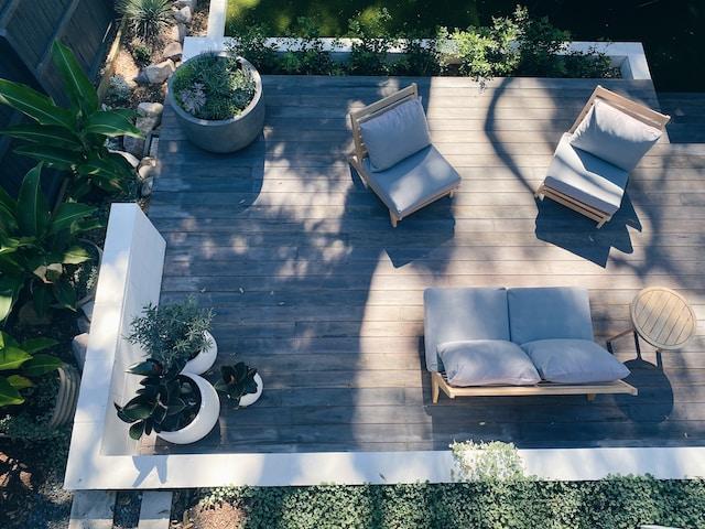 A patio with white furniture and plants