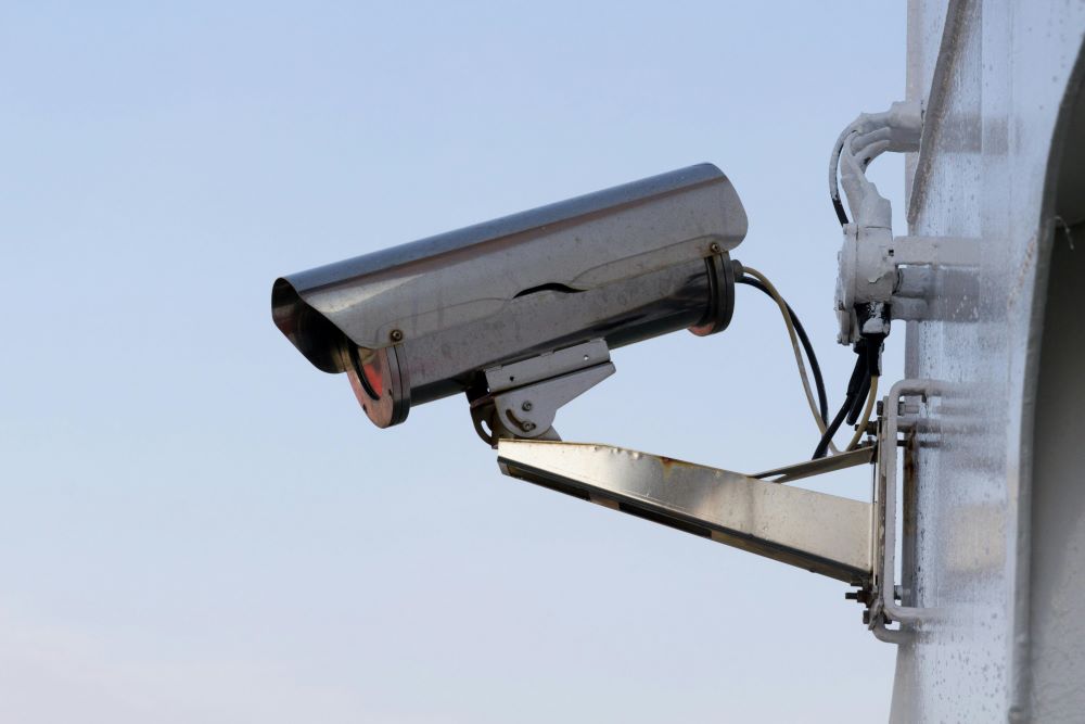 A silver security camera that monitors the area