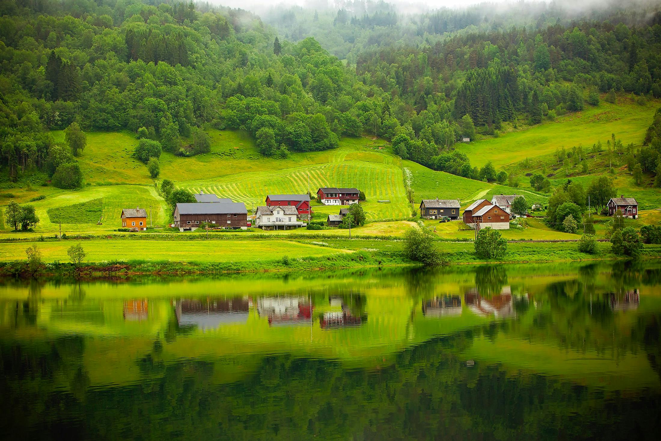 Red and brown houses near a lake