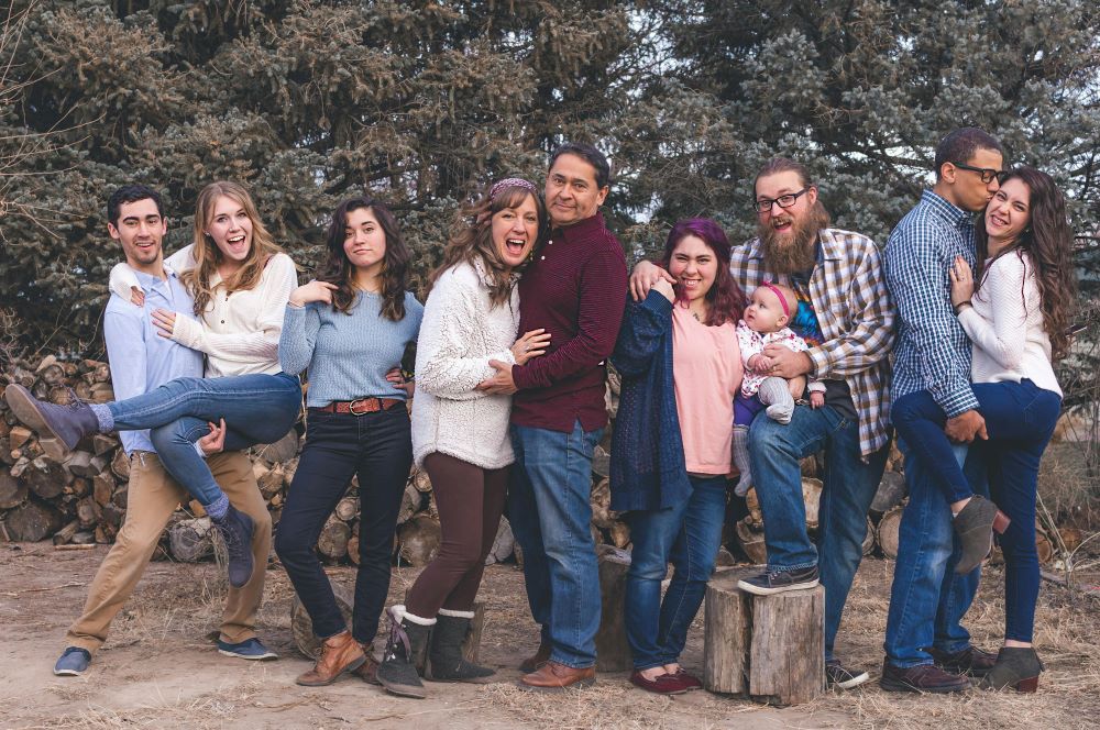 A big family taking a picture together after building a vacation home