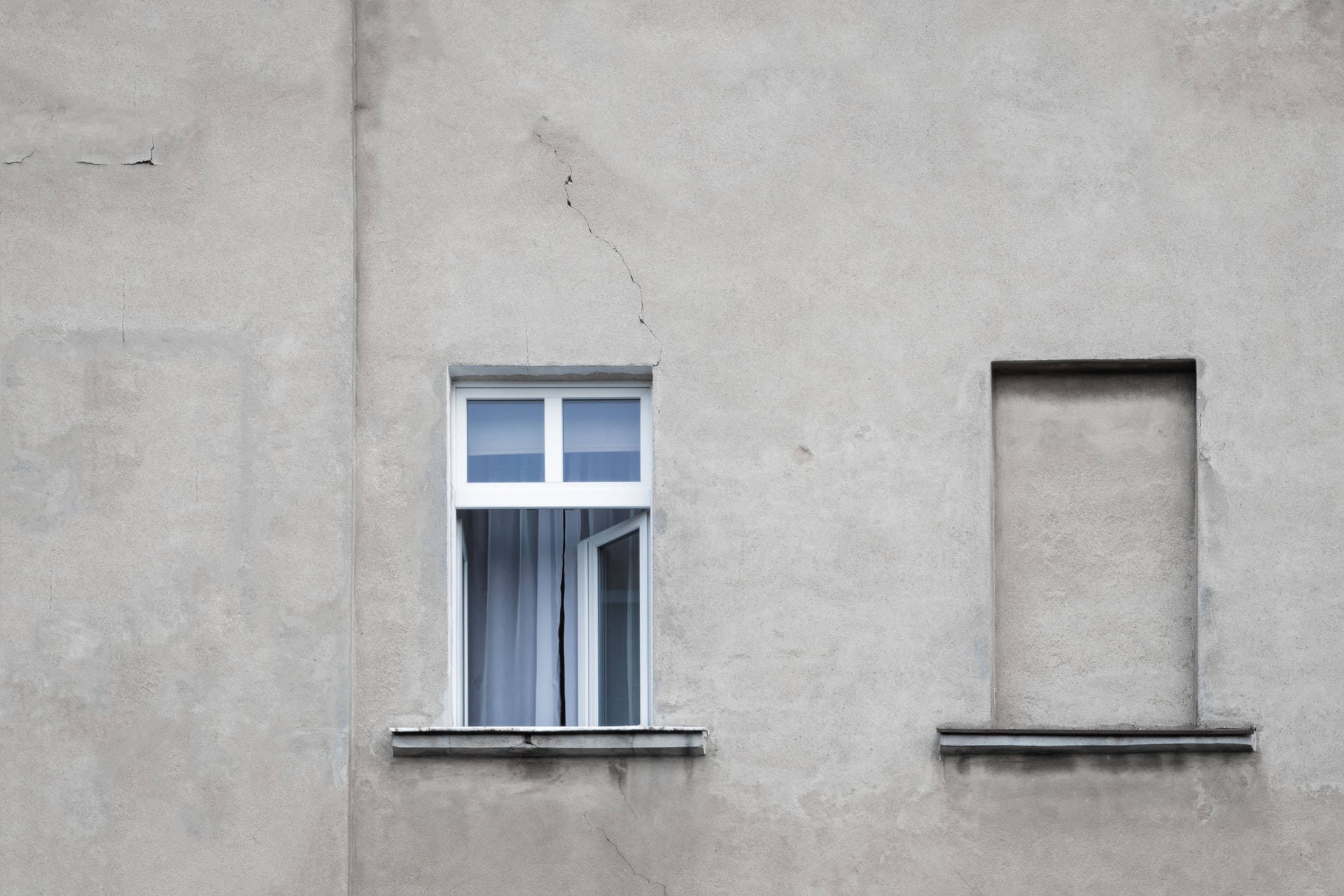 Exterior wall with cracks around the window