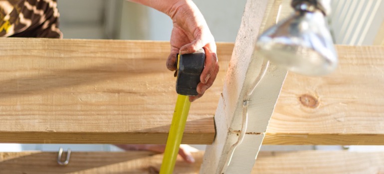 A construction worker taking measurements