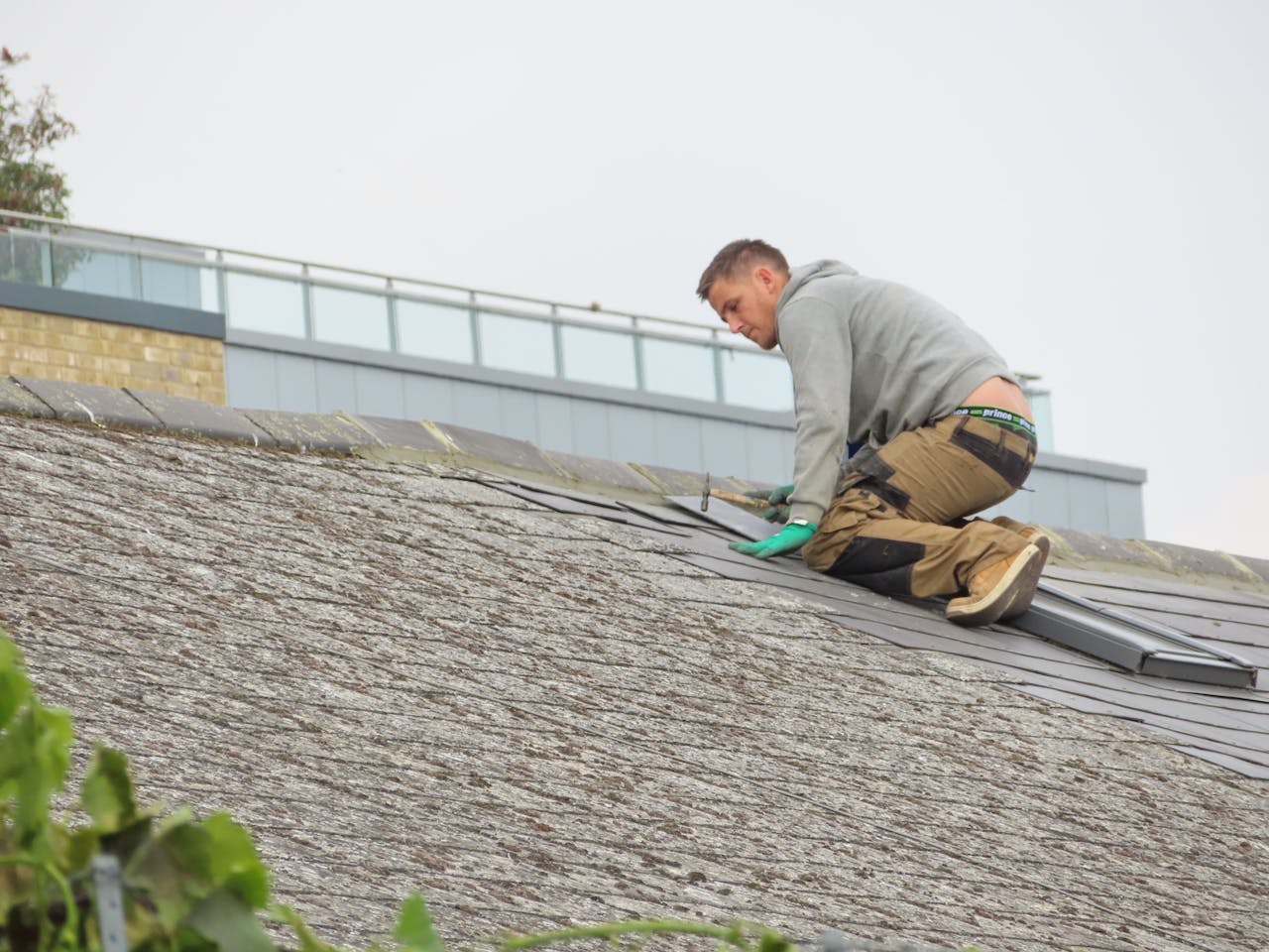 Handyman putting roof tiles
