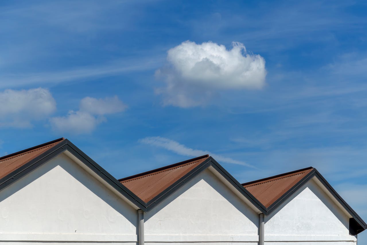 Triangular roofs against a clear sky