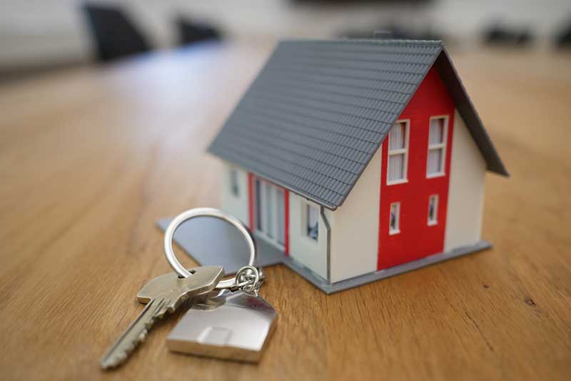 A key next to a miniature house.
