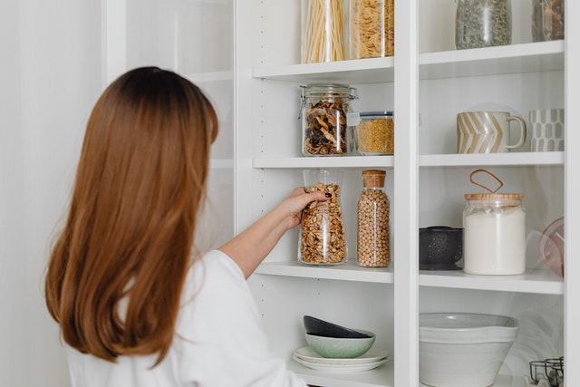 A woman holding a glass jar 