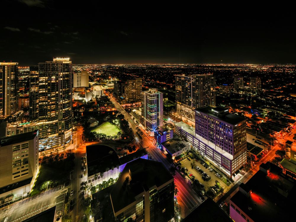 Skyscrapers and multistory buildings at night. Caption: Coastal cities have an amazing nightlife.