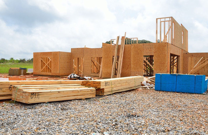 New home under construction using stacks of lumber.