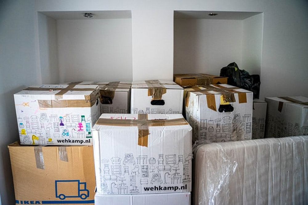 Stacks of moving boxes in an empty room