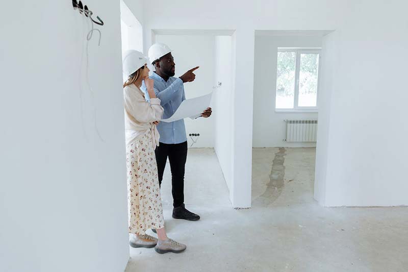 A couple inspecting their future home.