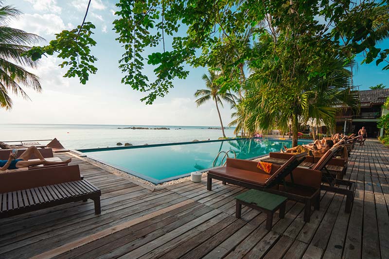 An outdoor pool overlooking the ocean as an example of designing outdoor spaces for coastal comfort